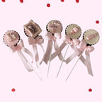 Sweet Snap Sydney baby shower chocolate lollies with pink bows, featuring teddy bear, ABC blocks, and baby bottle designs.