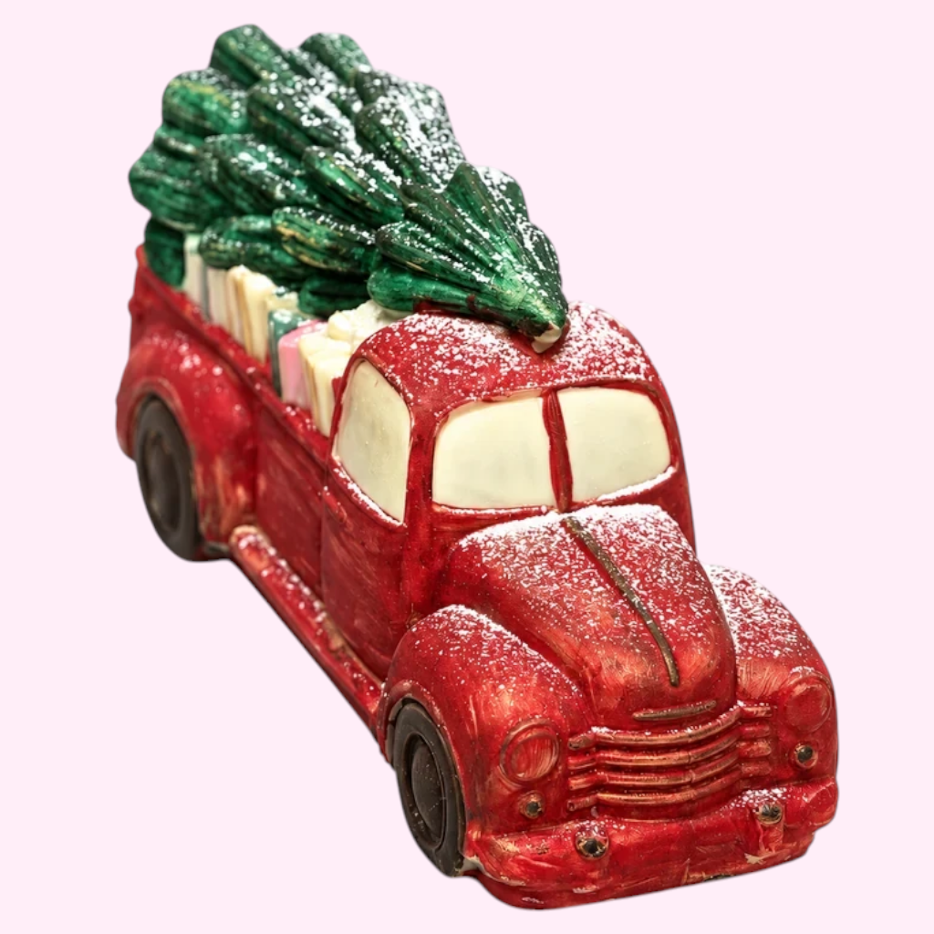 Sweet Snap Sydney handcrafted red chocolate truck carrying a Christmas tree and gifts with a dusting of sugar snow.