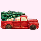 Sweet Snap Sydney handcrafted red chocolate truck carrying a Christmas tree and gifts, dusted with festive snow.