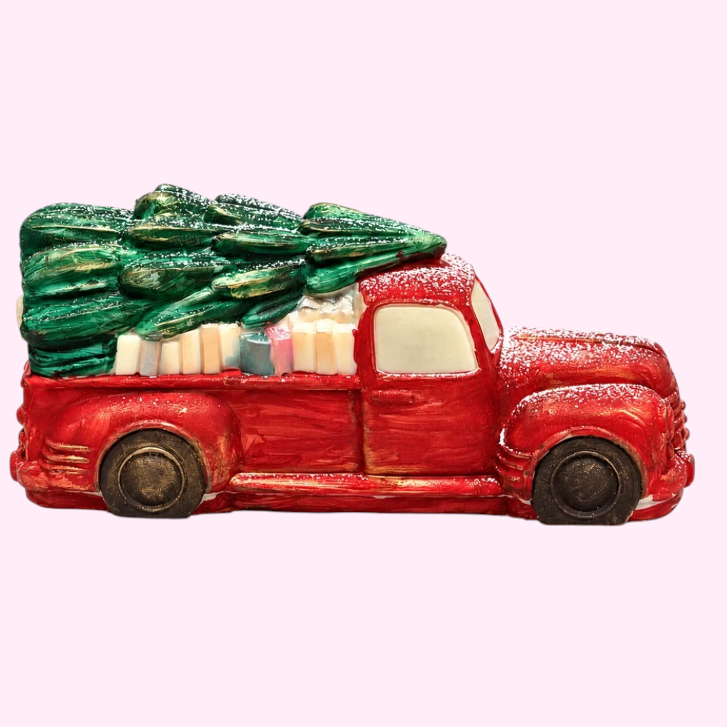 Sweet Snap Sydney handcrafted red chocolate truck carrying a Christmas tree and gifts, dusted with festive snow.