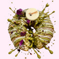 Sweet Snap Sydney customised donut with pistachio glaze, white chocolate drizzle, edible flowers, and personalised chocolate disc.
