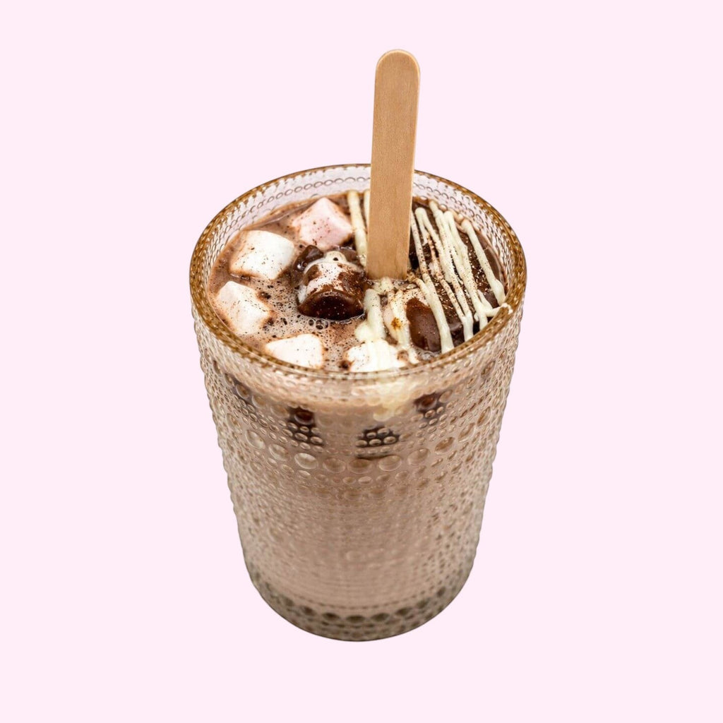 Sweet Snap Sydney hot chocolate bomb dissolving in a glass with marshmallows and white chocolate drizzle.