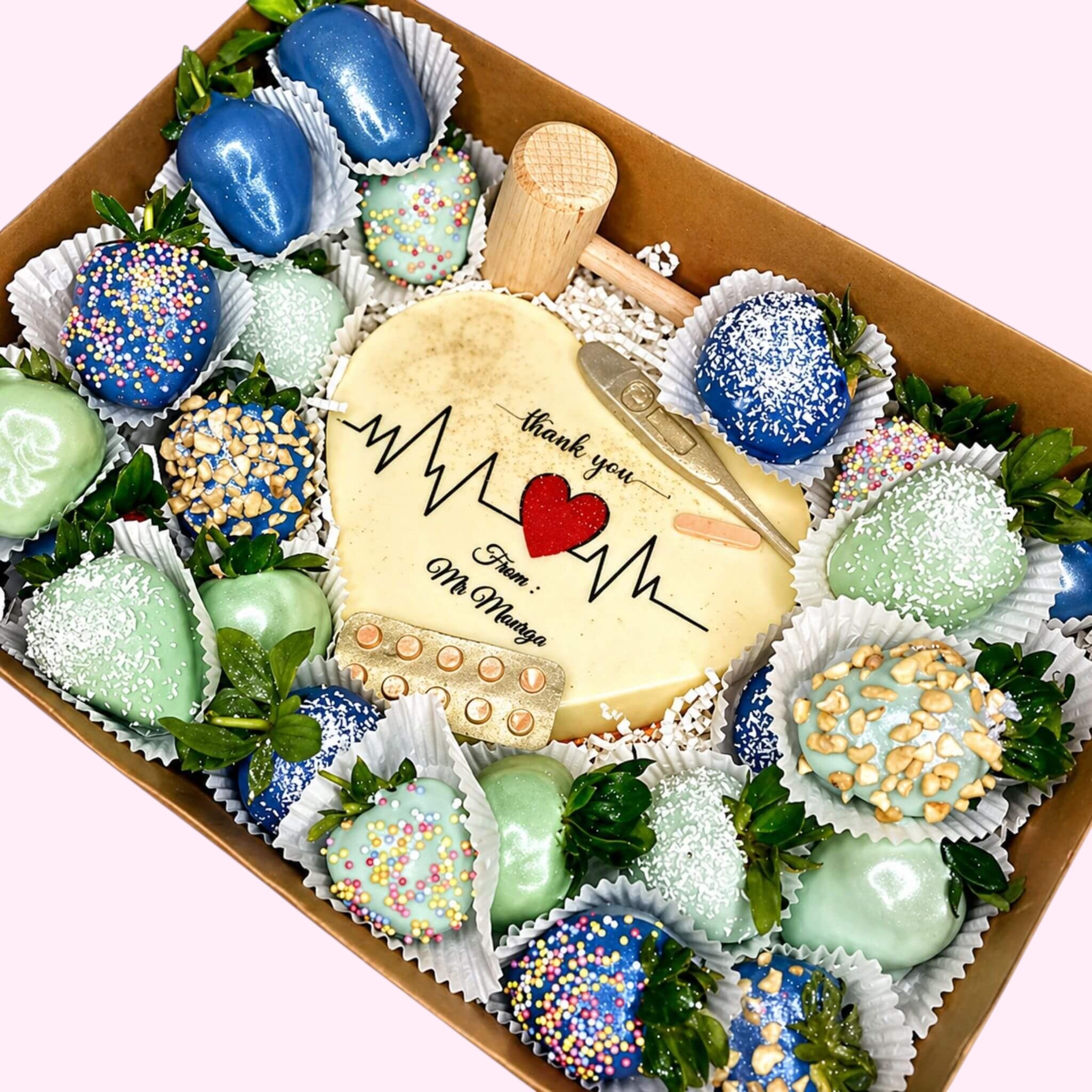 Sweet Snap Sydney chocolate-covered strawberries and heart-shaped cookie with medical theme, blue, green, and yellow.