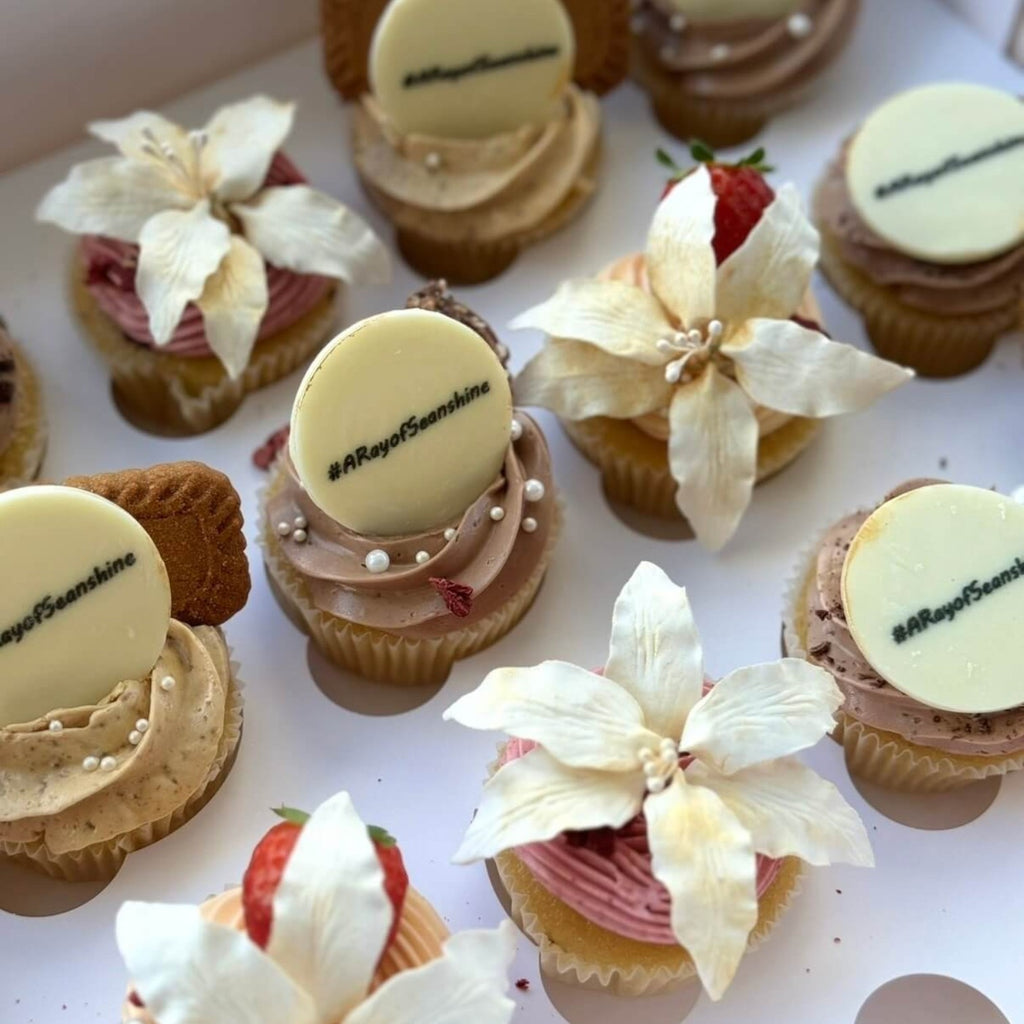 Sweet Snap Sydney chocolate cupcakes with personalised white chocolate discs, edible flowers, and strawberries.