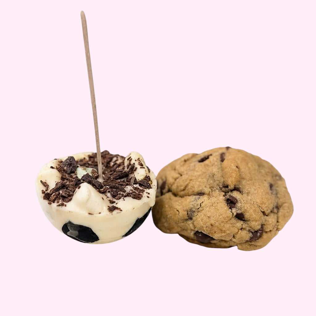 Sweet Snap Sydney white chocolate soccer hot chocolate bomb with dark chocolate shavings and a cookie.