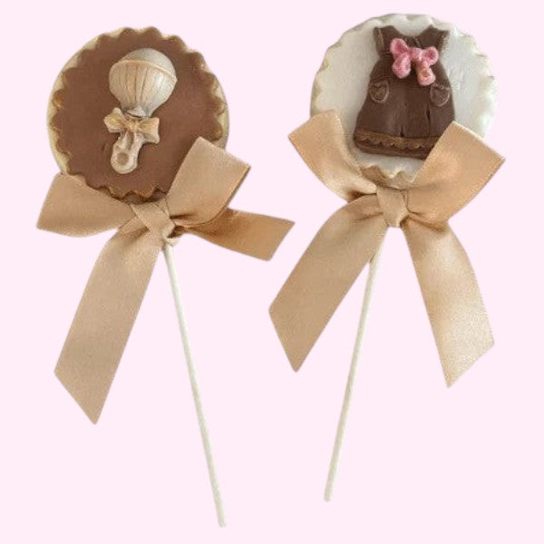 Sweet Snap Sydney baby shower chocolate lollies with rattle and dress designs, tied with satin bows.