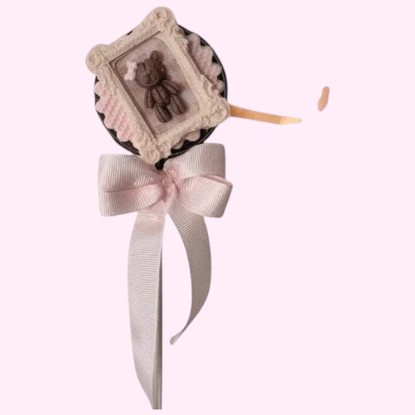 Sweet Snap Sydney baby shower chocolate lolly with teddy bear design, white chocolate, pink ribbon bow, and confetti.