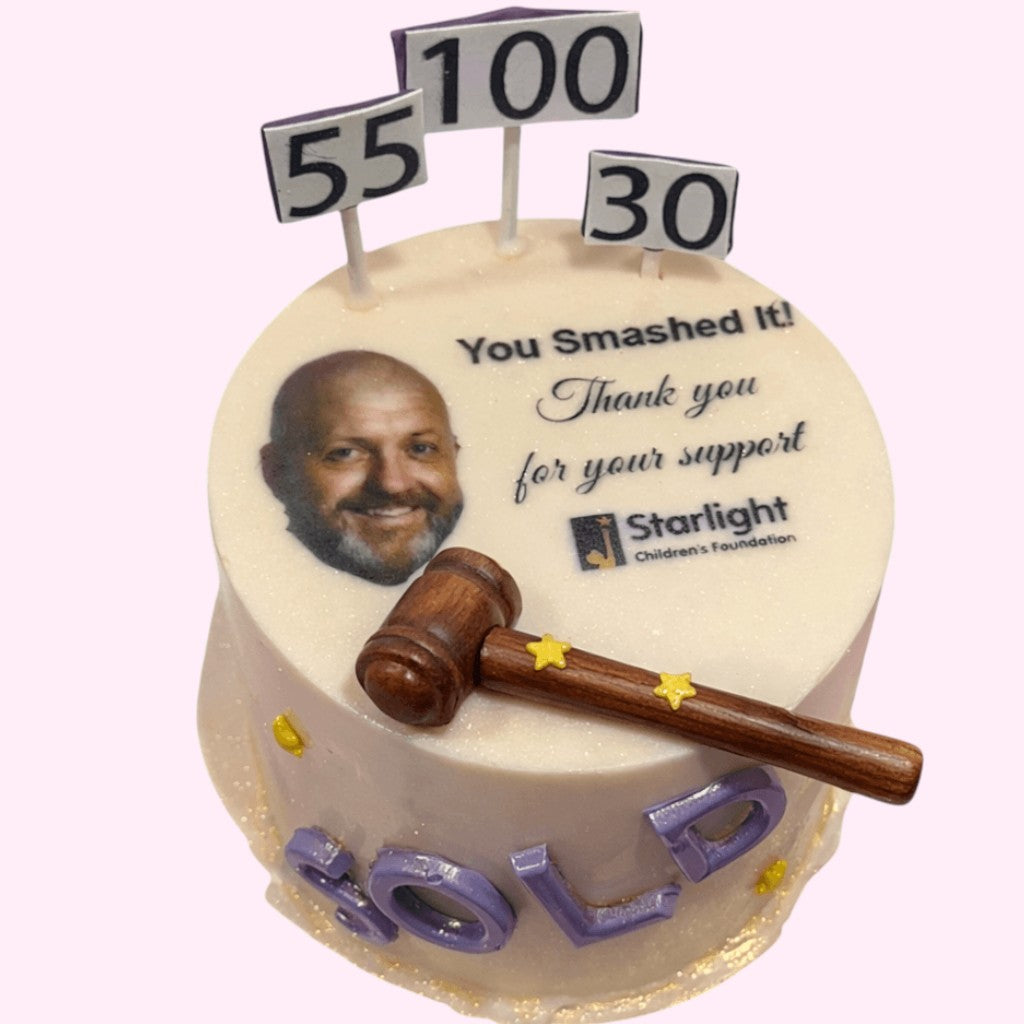 Sweet Snap Sydney custom round cake with a photo, 'You Smashed It! Thank you for your support' text, Starlight Children's Foundation logo, gavel, and 'SOLD' icing.
