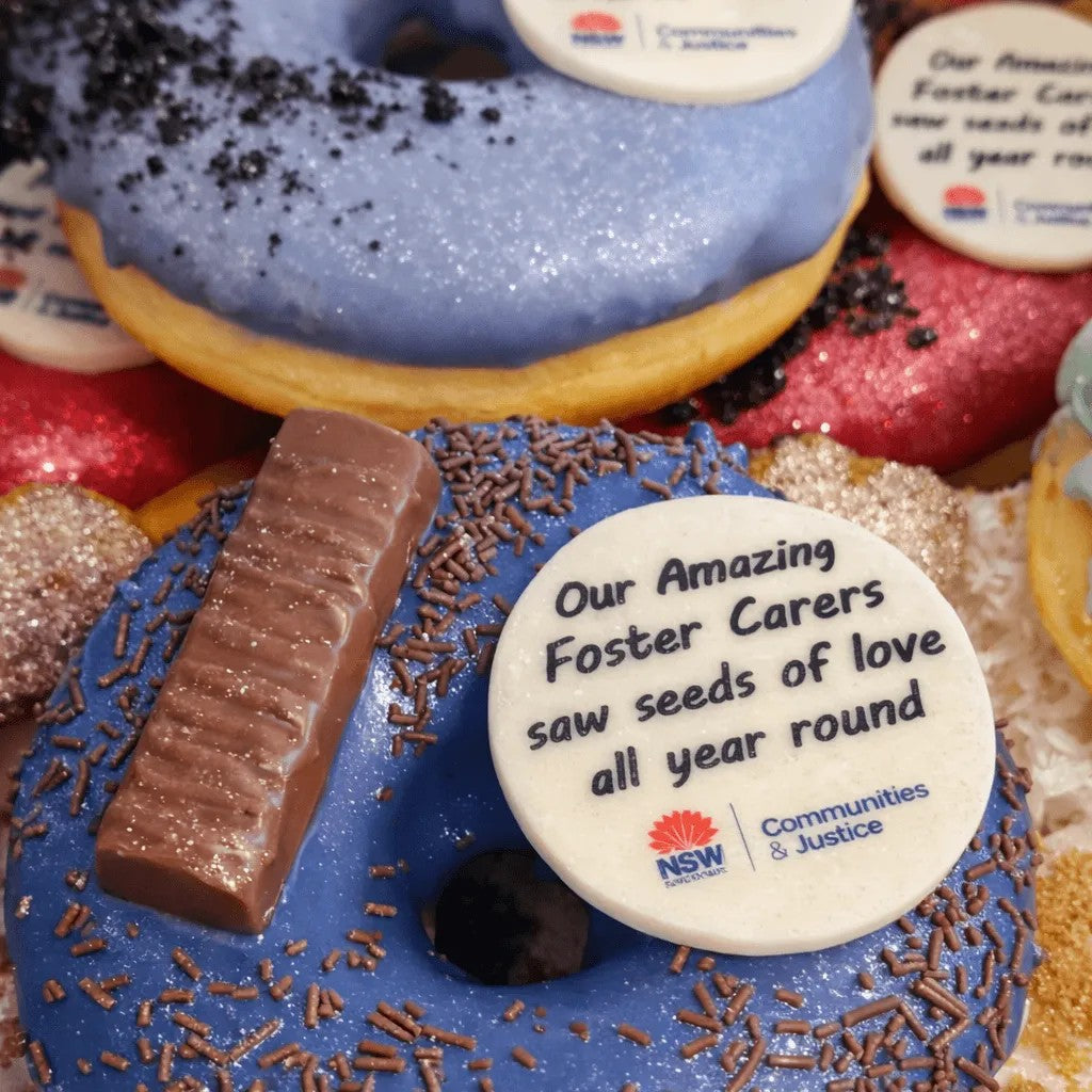 Sweet Snap Sydney blue iced donut with chocolate sprinkles, a chocolate bar, and a custom message disc for Foster Carers.