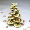 White chocolate and pistachio Christmas tree decorated with dried fruit and nuts